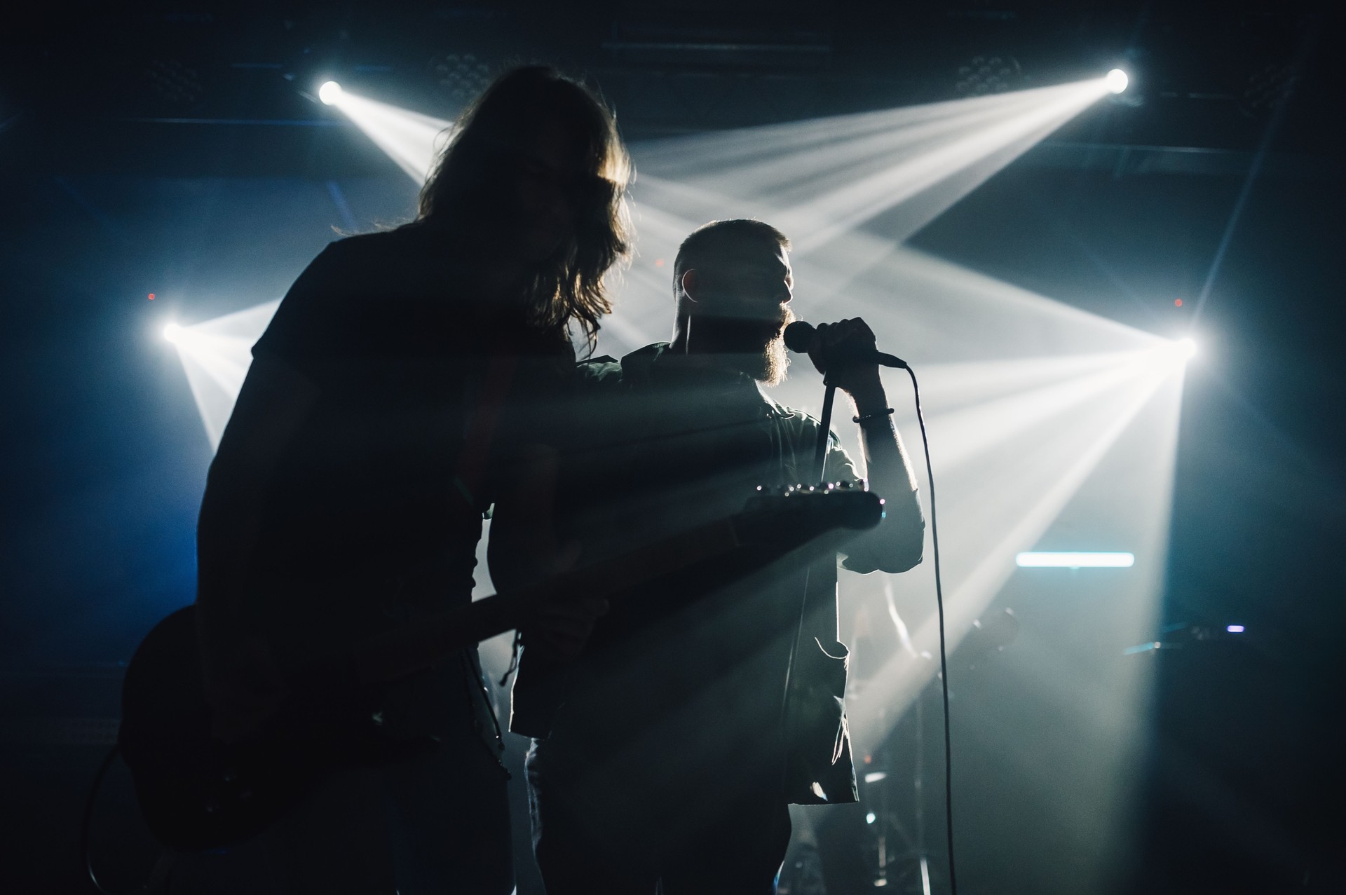 Rock band performing live on stage under stage lights