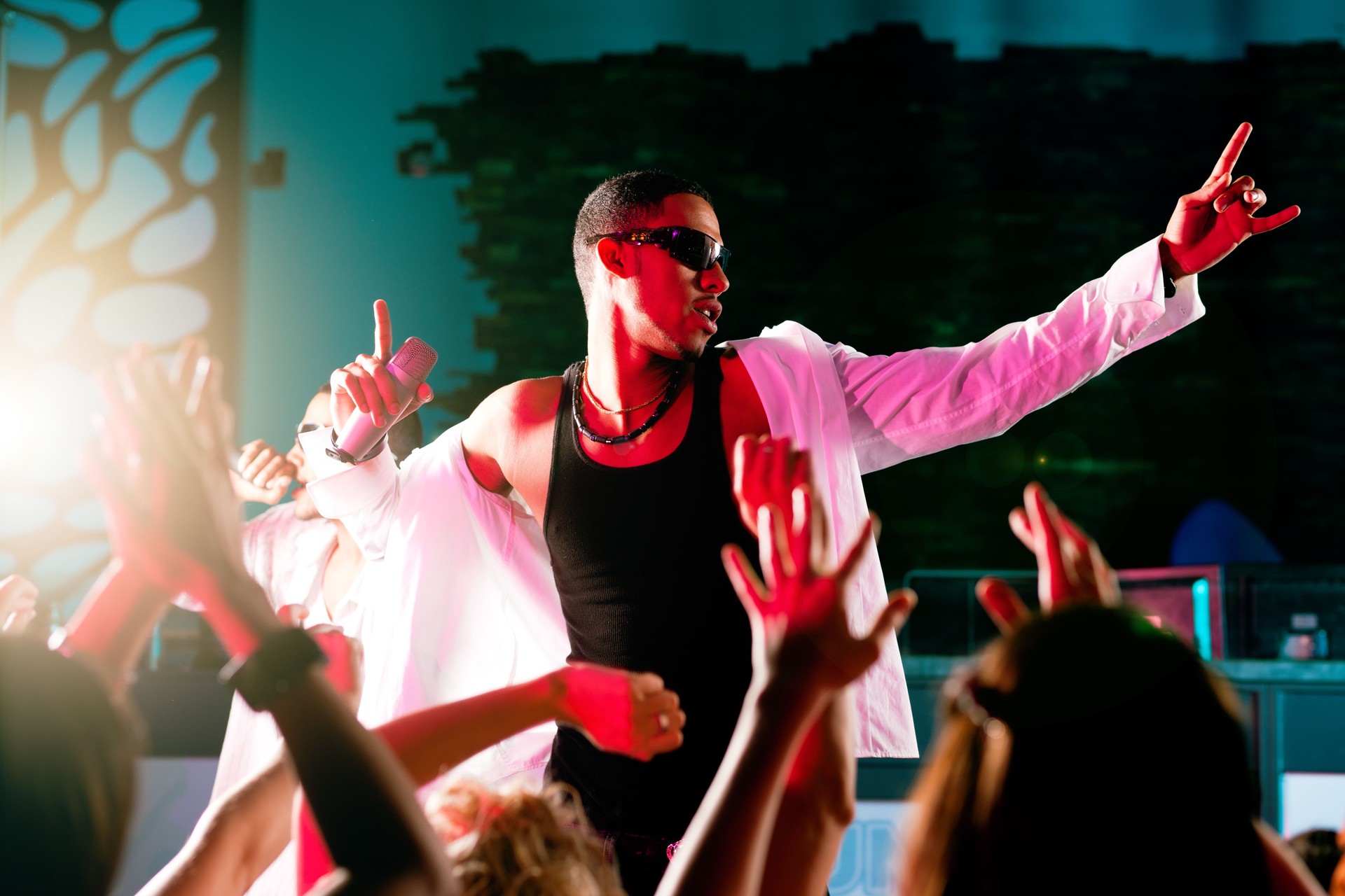 Hip-hop musician performing on stage with a crowd